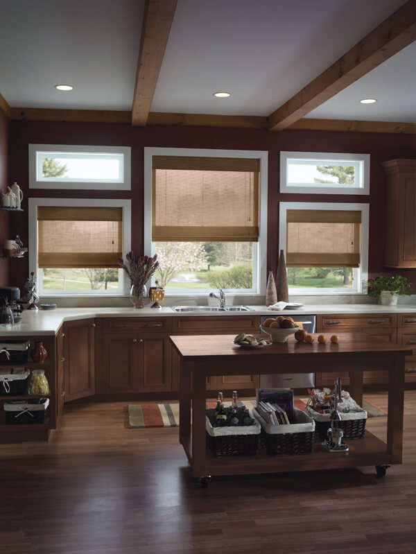 kitchen with dark wood cupboards and floors; bamboo blinds on windows