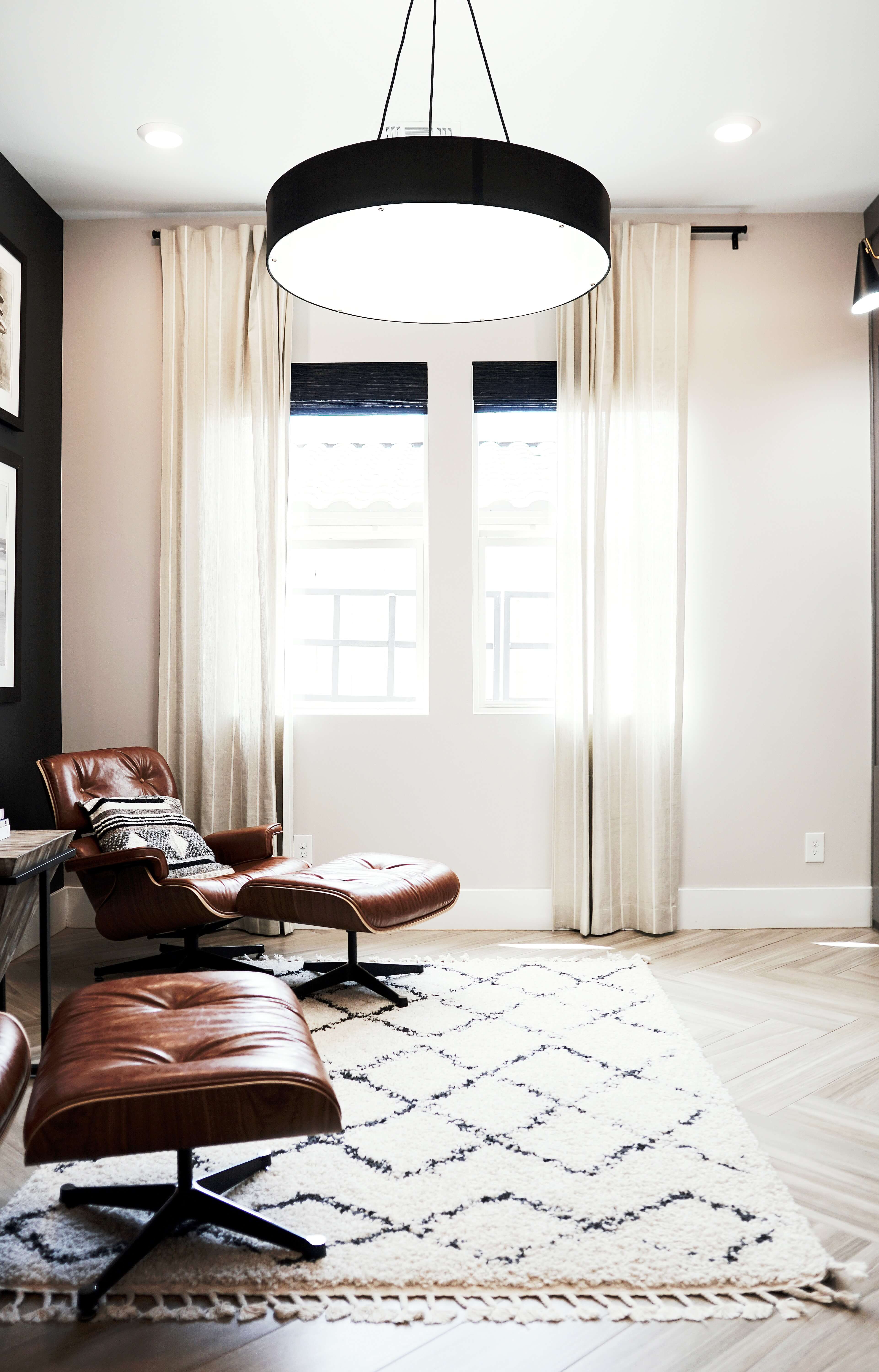 light drapery panels over dark shades in cozy room/office