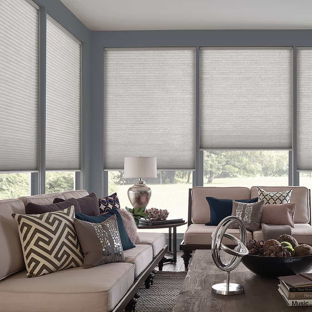 gray cellular shades on floor-to-ceiling windows in a living room