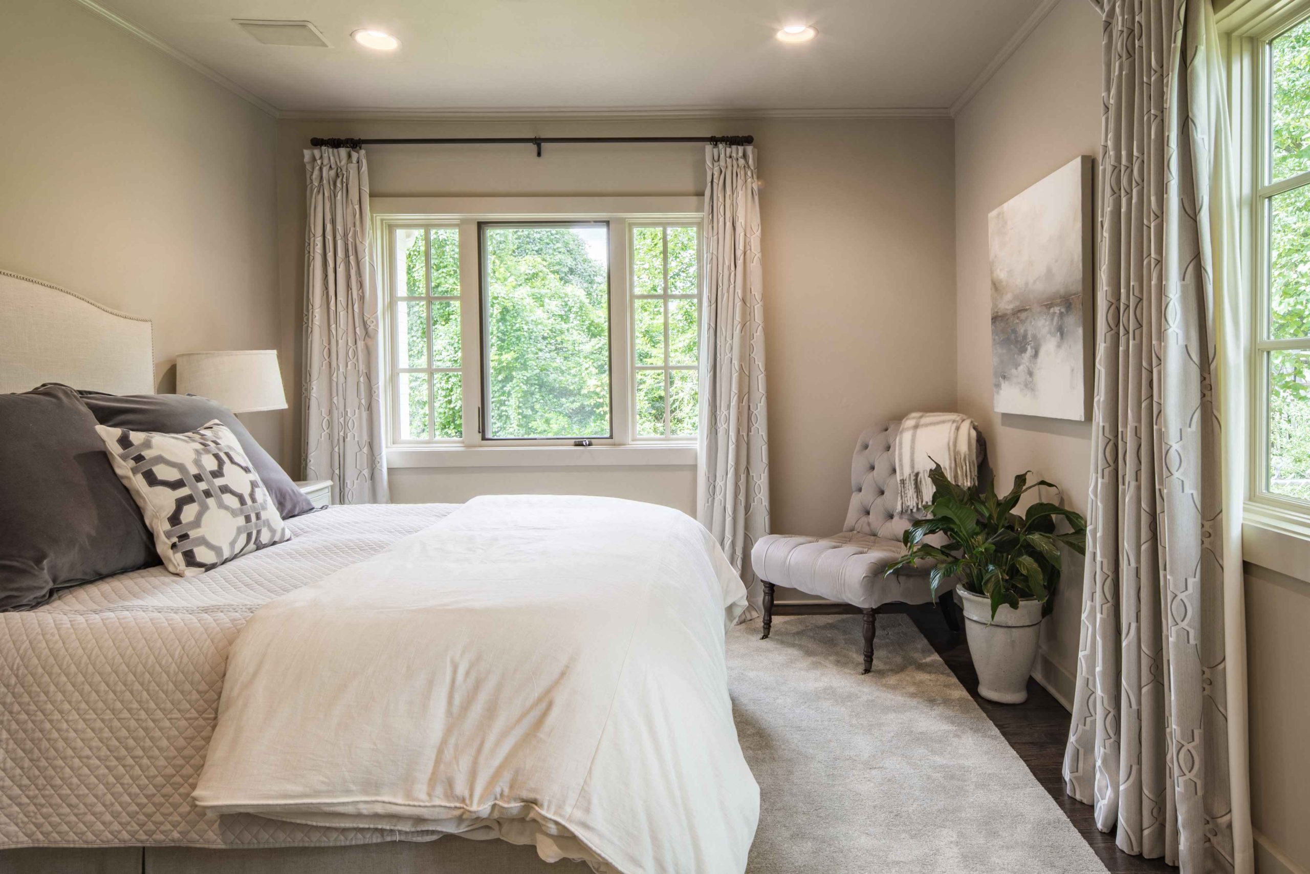 Bedroom with drapes on the windows
