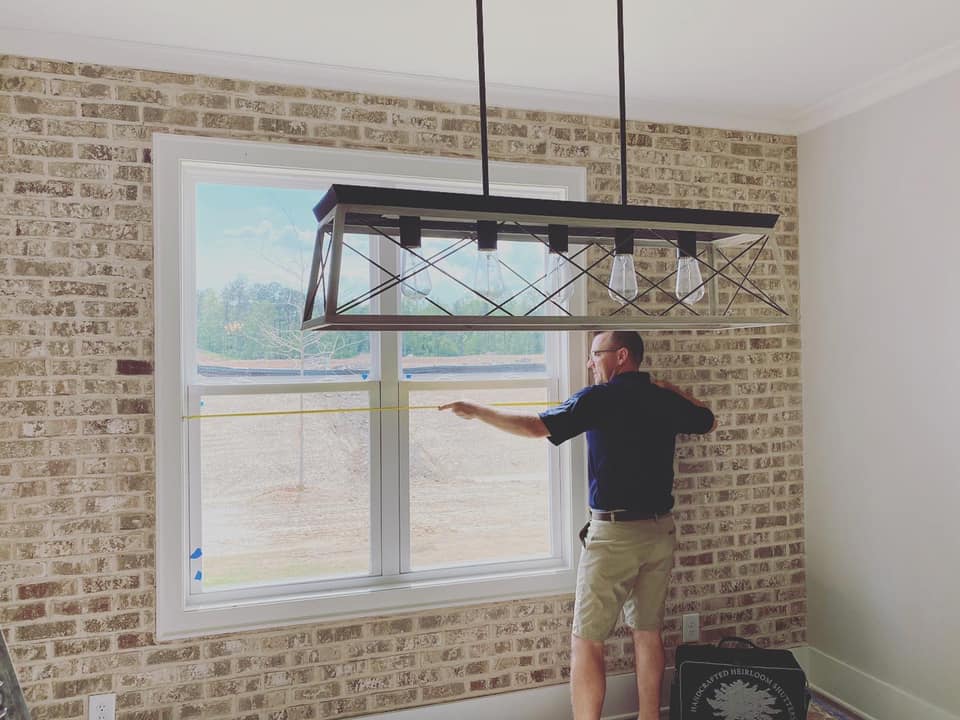 Man installing window coverings