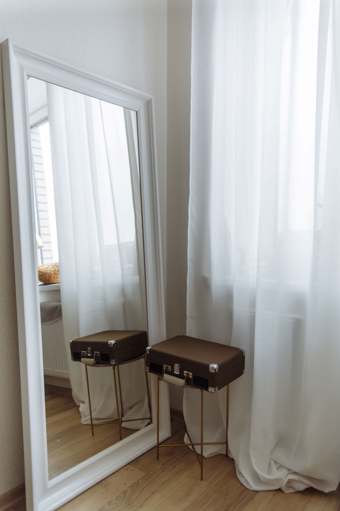room with a tall vertical mirror