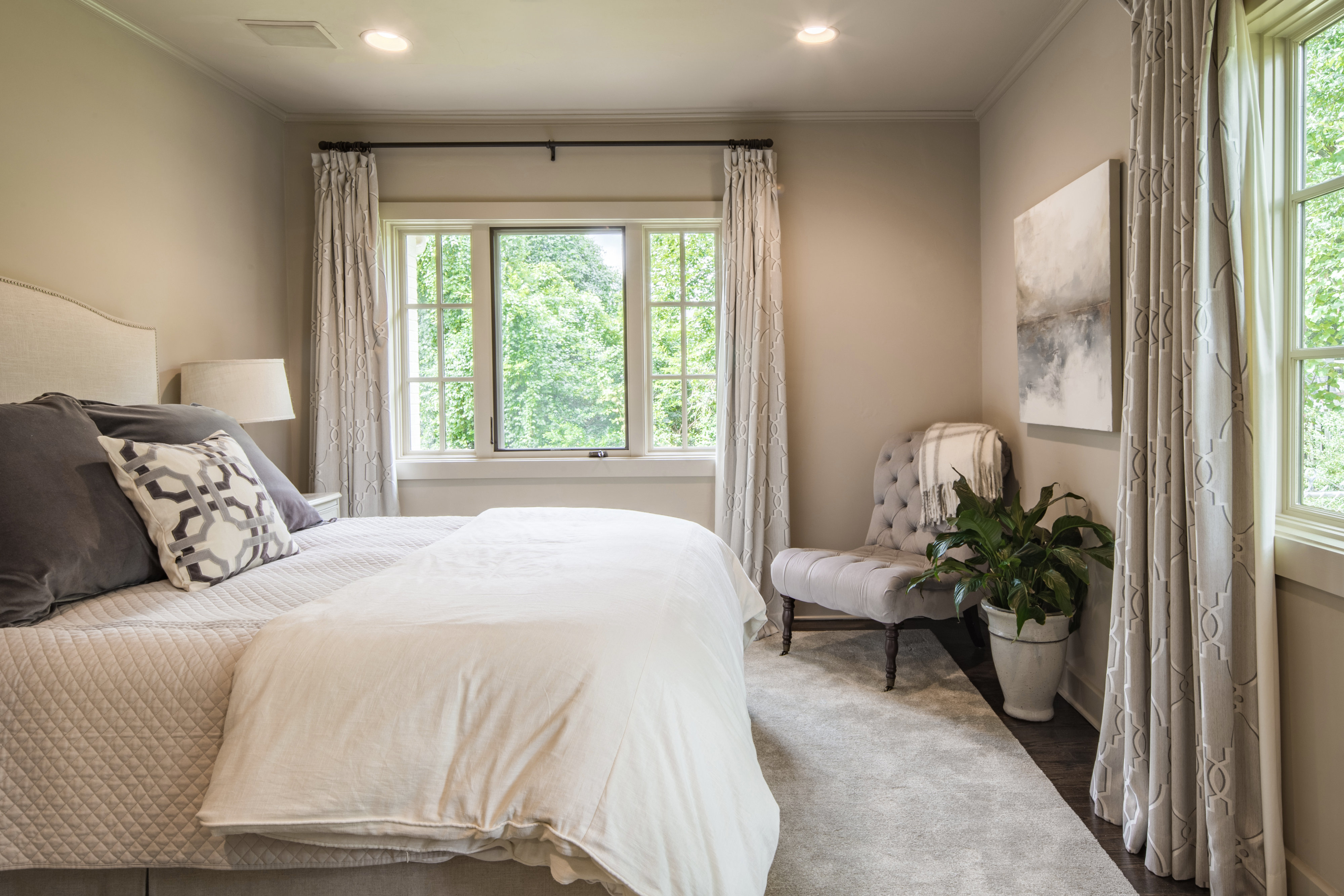 Bedroom with drapes on the windows